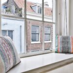 Cushions on windowsill near window