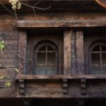 Old wooden house with wooden windows and shutters.